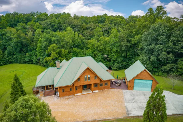 a view of a house with a yard from a lake view