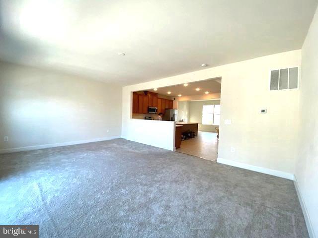 10726 Shadewell Spring Way Manassas, VA 20112 - Photo 11 of 29 a view of an empty room with a kitchen