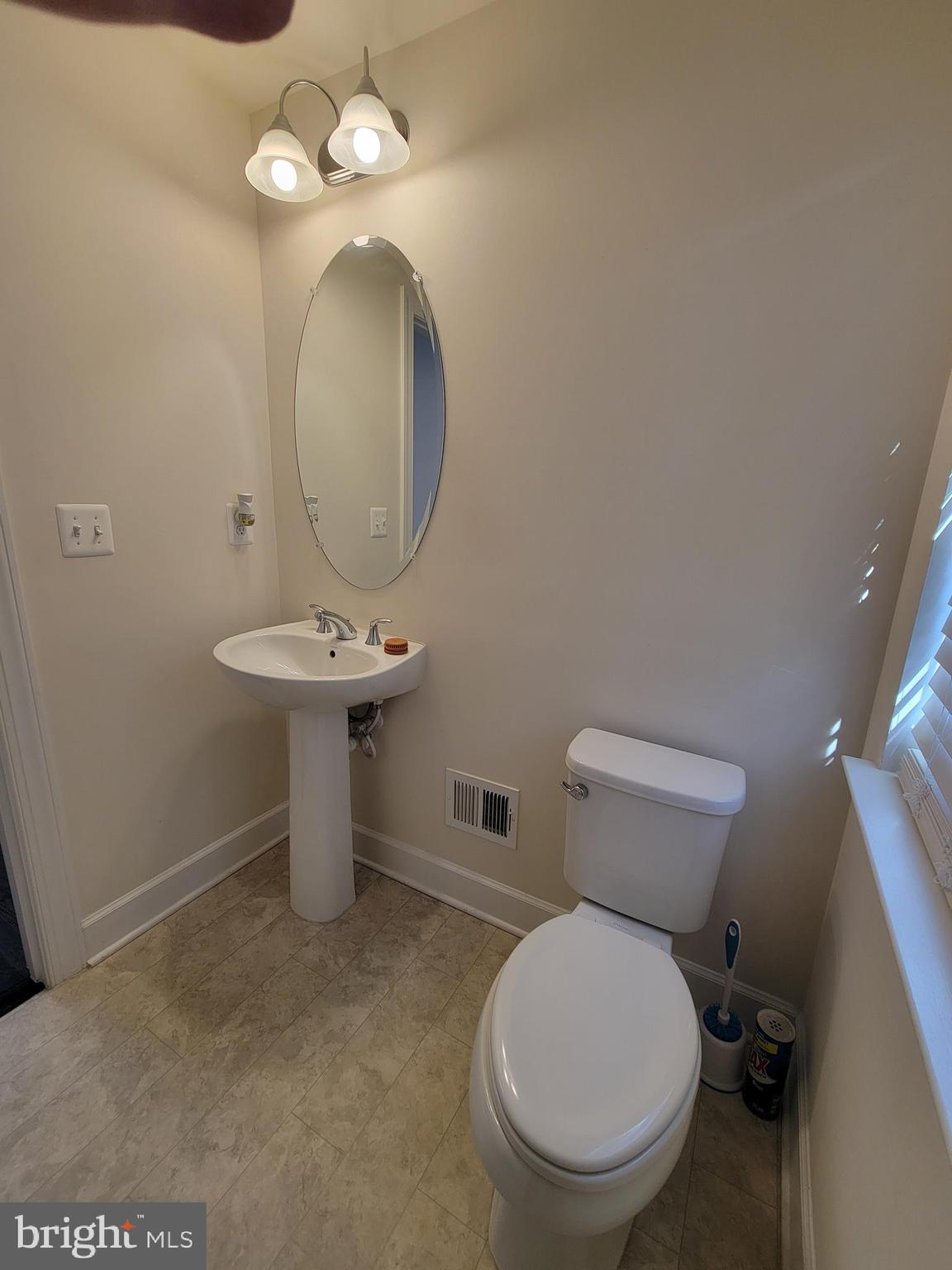 10726 Shadewell Spring Way Manassas, VA 20112 - Photo 19 of 29 a bathroom with a toilet sink and mirror