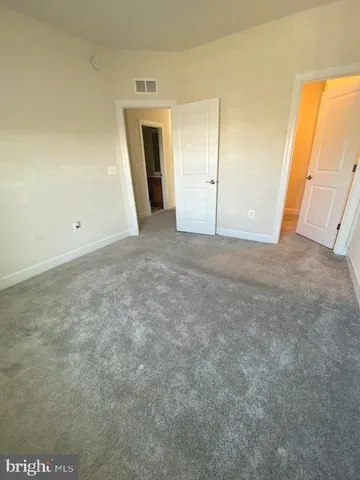 a view of an empty room with a fireplace