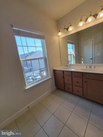 a bathroom with a sink vanity and mirror