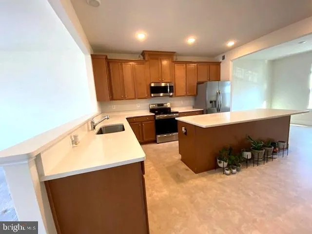 a kitchen with a sink a stove and chairs