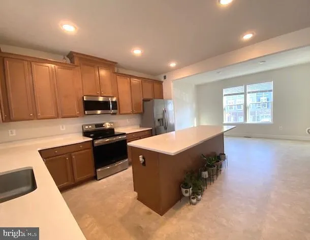 a kitchen with a stove a sink and a microwave