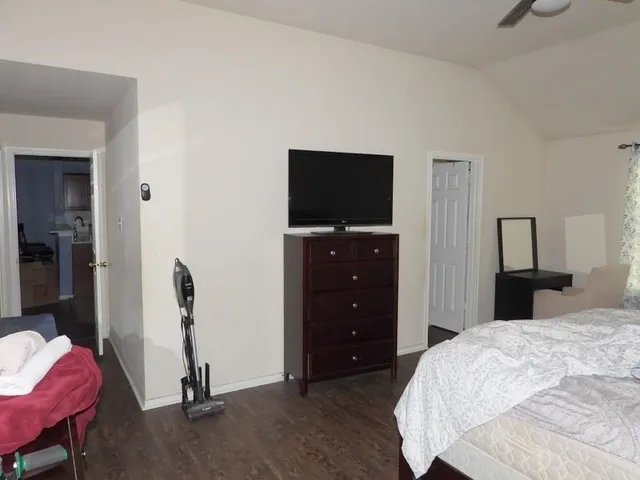 a bedroom with a bed and a television