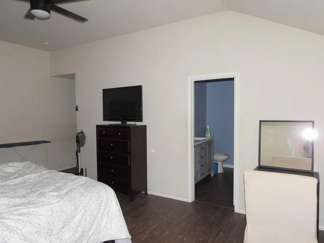 a bedroom with a bed and a television in it