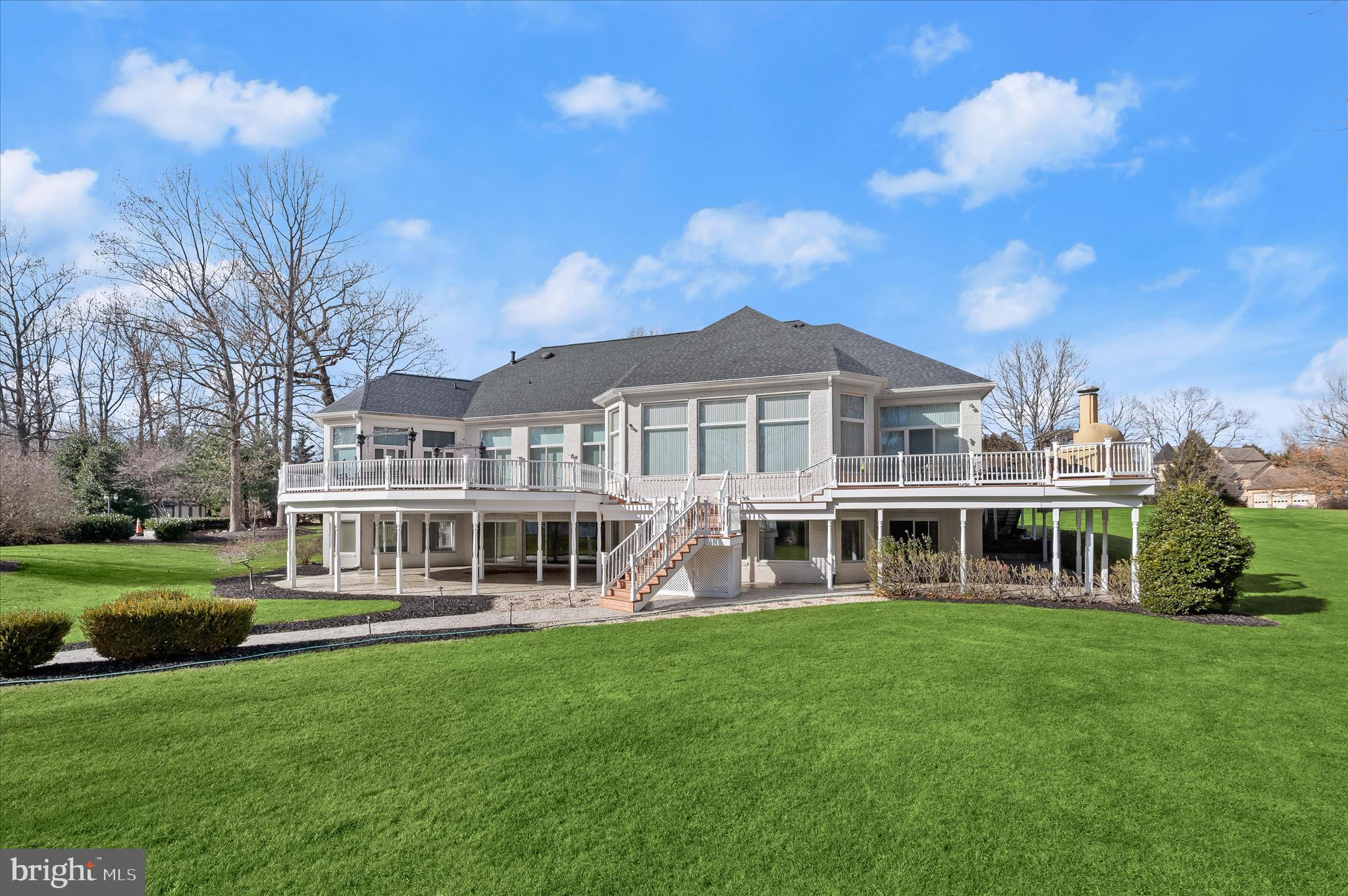 a view of a house with a yard and sitting area