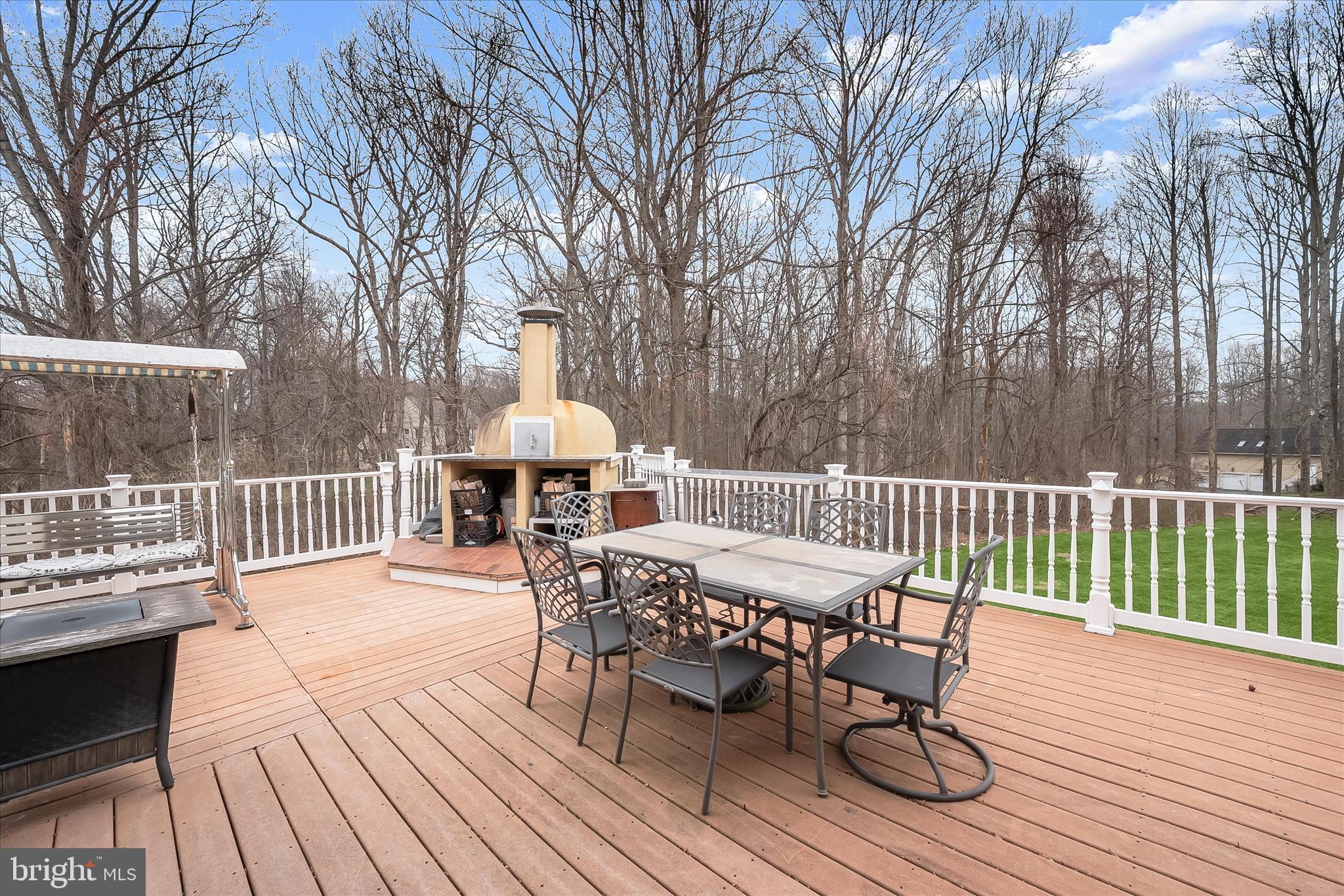 11678 Frederick Road Ellicott City, MD 21042 - Photo 105 of 118 a view of a roof deck with table and chairs and wooden floor
