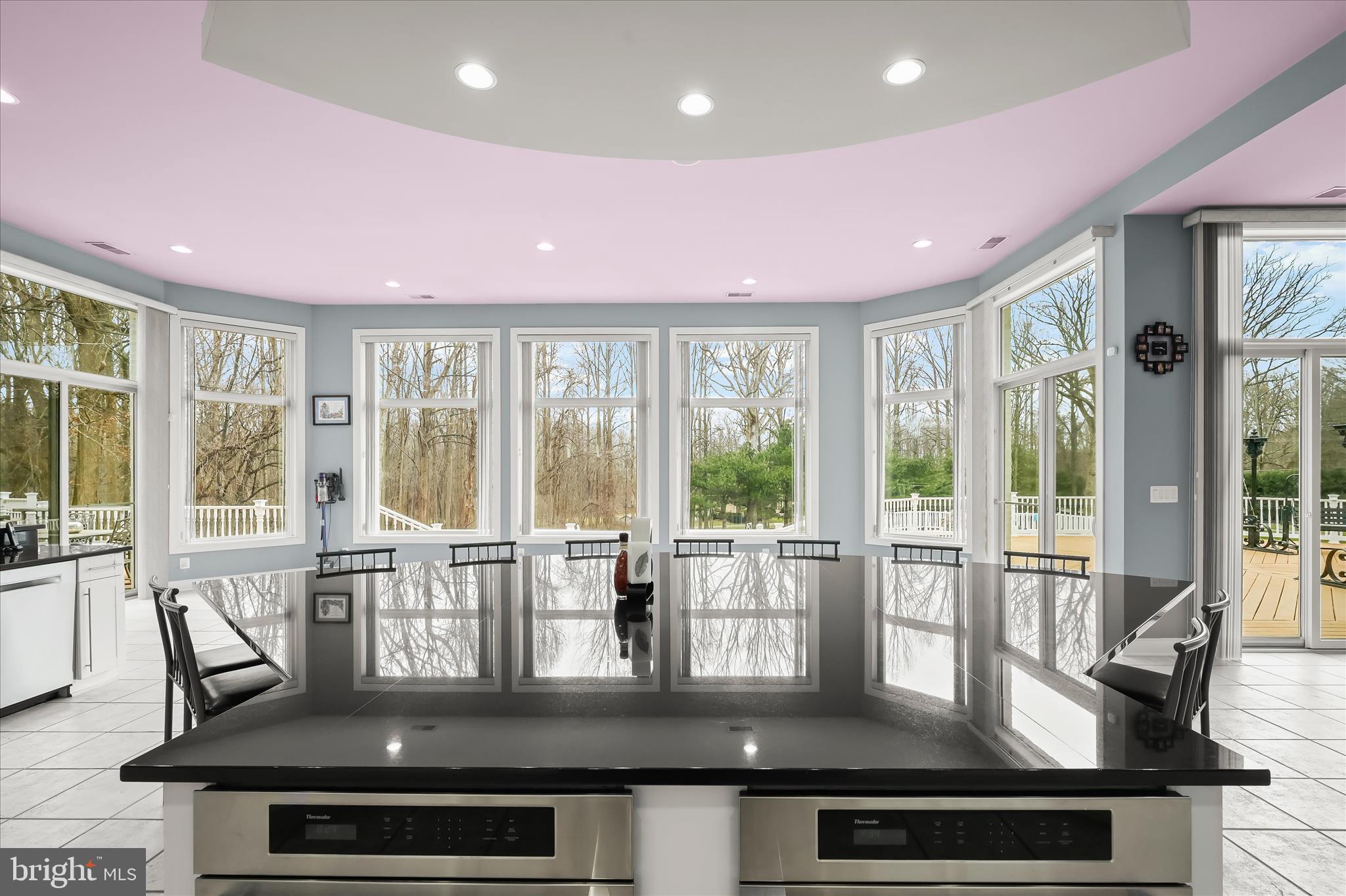 11678 Frederick Road Ellicott City, MD 21042 - Photo 44 of 118 a view of a dining room with furniture large windows and wooden floor