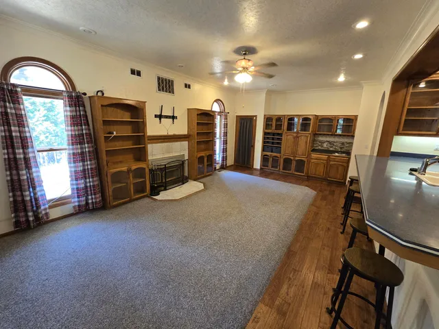 a large kitchen with stainless steel appliances a large counter top