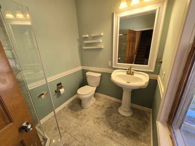 a view of empty room with wooden floor and windows