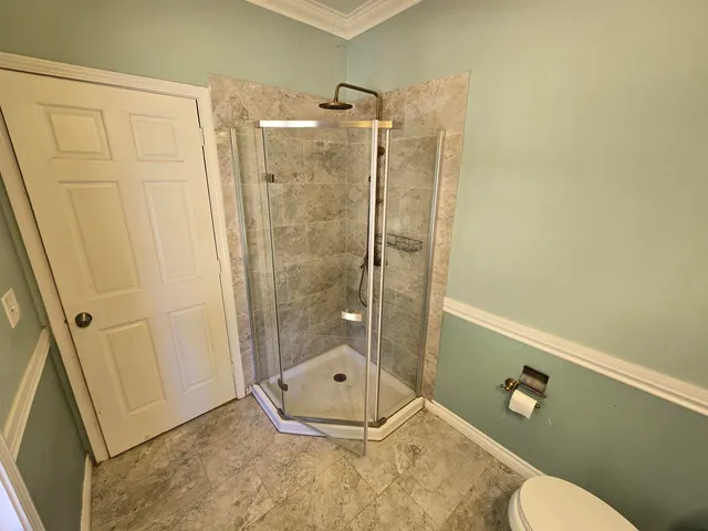 a view of an empty room with a fireplace and a window