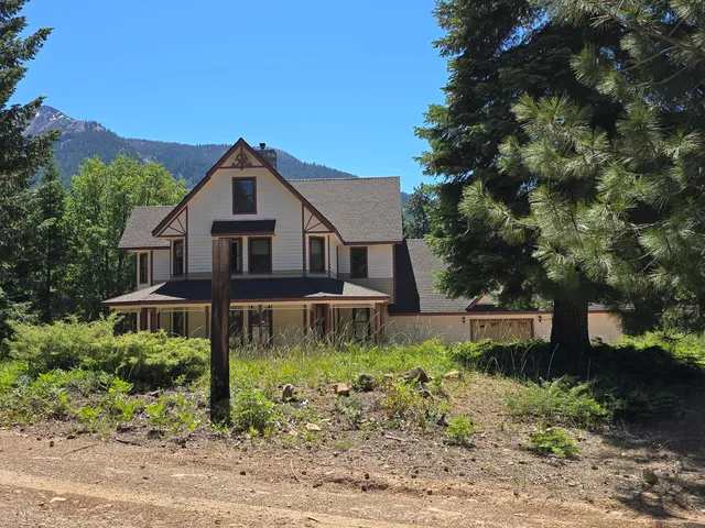 a view of a house with a yard and tree s