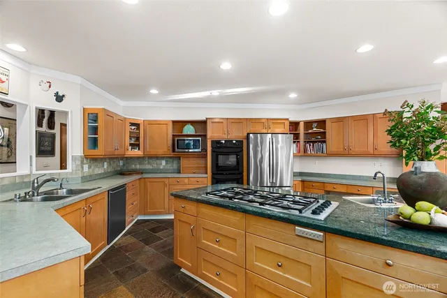 a kitchen with granite countertop lots of counter top space and stainless steel appliances