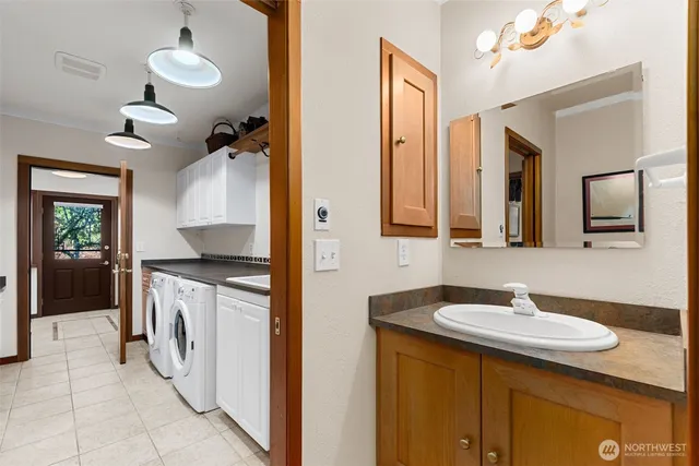 a spacious bathroom with a granite countertop sink and a mirror
