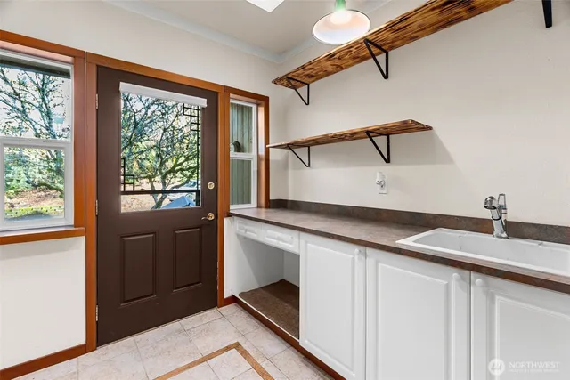 a kitchen with a refrigerator and a sink