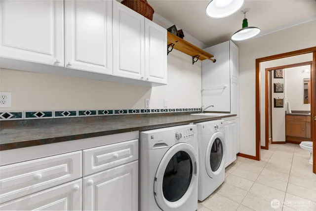 a utility room with sink dryer and washer