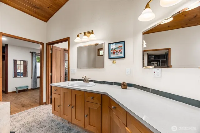 a bathroom with a sink a mirror and a bathtub