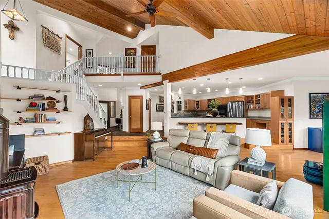 a living room with furniture a rug and kitchen view