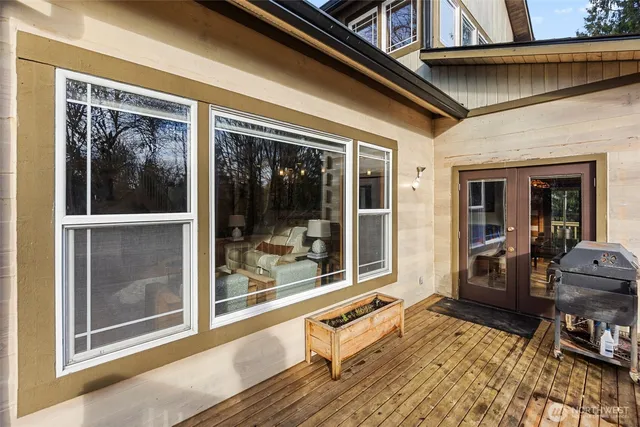 a view of a house with backyard and chairs