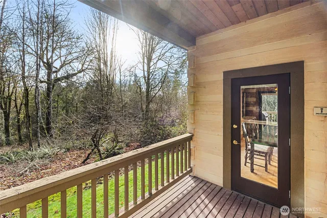 a view of a house with a yard and hanging chair