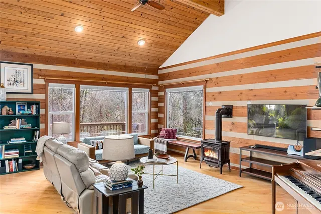 a living room with furniture and a floor to ceiling window