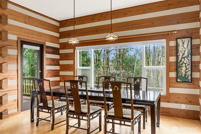 a view of a dining room with furniture large windows and wooden floor