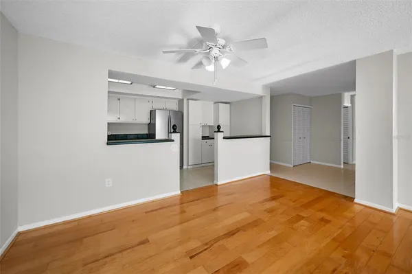 a view of a kitchen with a sink cabinets and wooden floor