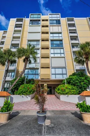 a view of a tall building next to a road