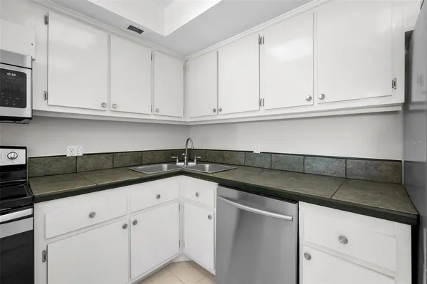 a kitchen with white cabinets and a sink