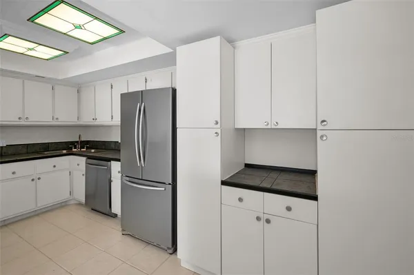 a kitchen with stainless steel appliances granite countertop a refrigerator and a stove