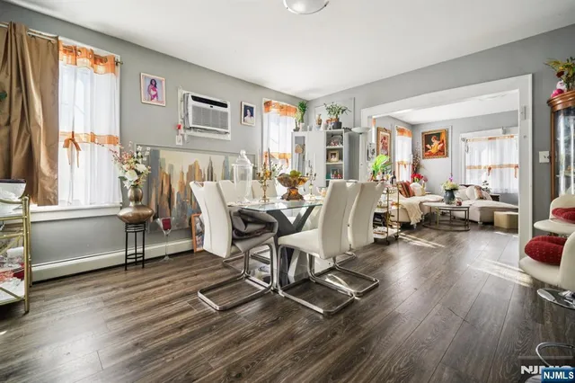 a living room with furniture a window and wooden floor