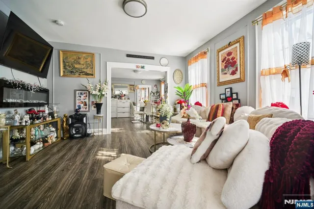 a bedroom with furniture and a flat screen tv