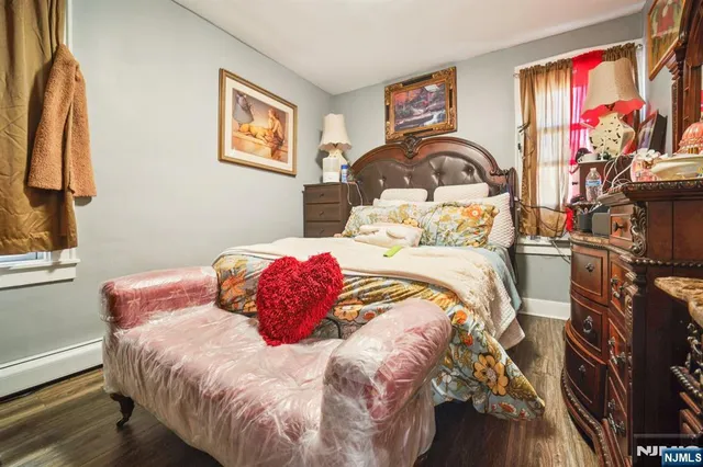 a bedroom with a bed and a painting on the wall