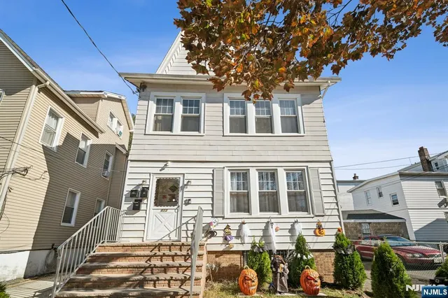 a front view of a house with many windows