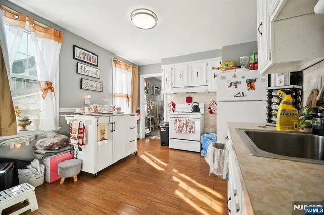 a living room with furniture and a kitchen view