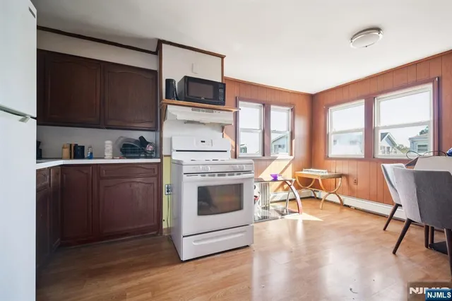 a kitchen with a stove a sink and a microwave