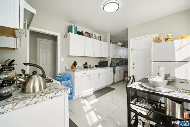 a kitchen that has a lot of cabinets in it and appliances