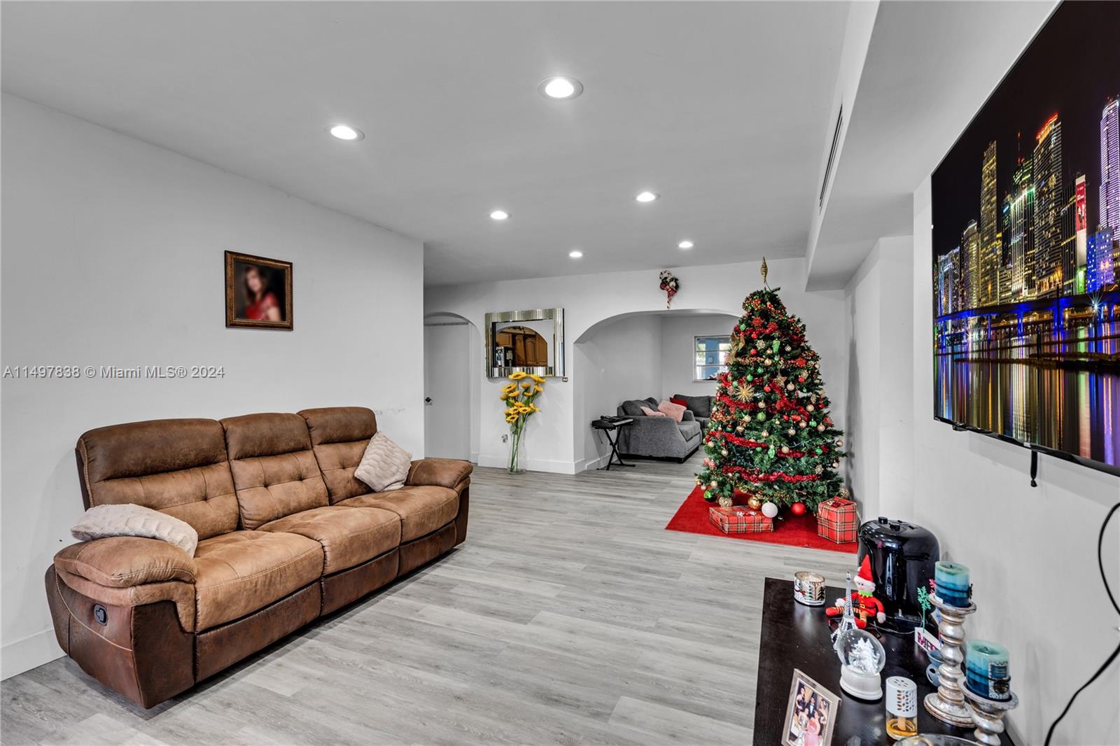 10981 Southwest 44th Street Miami, FL 33165 - Photo 11 of 52 a living room with furniture and a flat screen tv