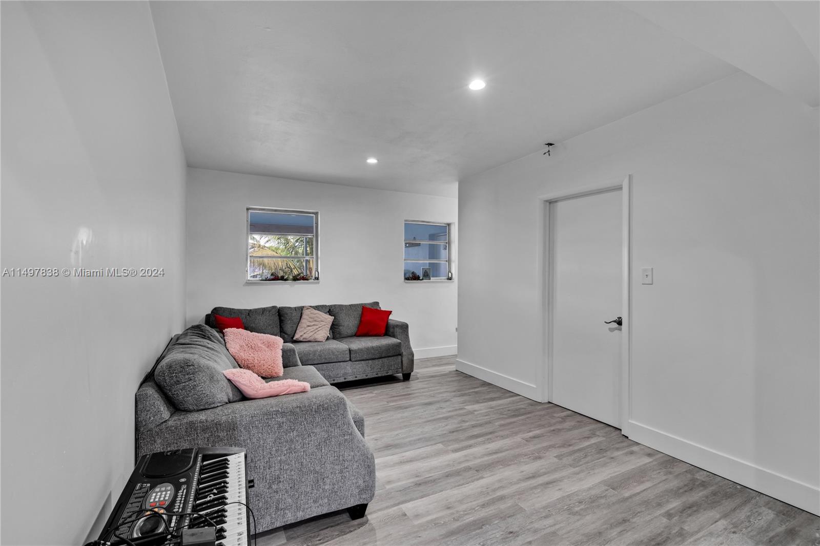10981 Southwest 44th Street Miami, FL 33165 - Photo 12 of 52 a living room with furniture and a wooden floor