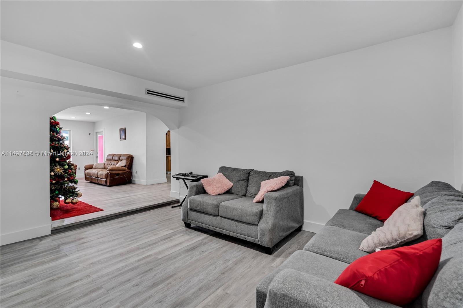 10981 Southwest 44th Street Miami, FL 33165 - Photo 13 of 52 a living room with furniture and a wooden floor