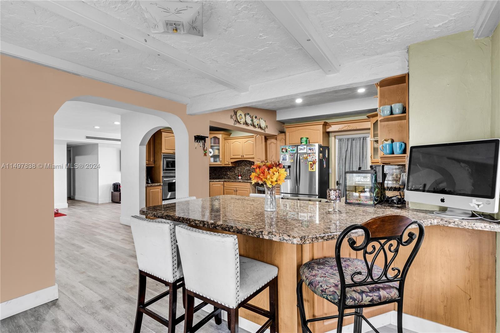 10981 Southwest 44th Street Miami, FL 33165 - Photo 17 of 52 a dining room with furniture and a flat screen tv