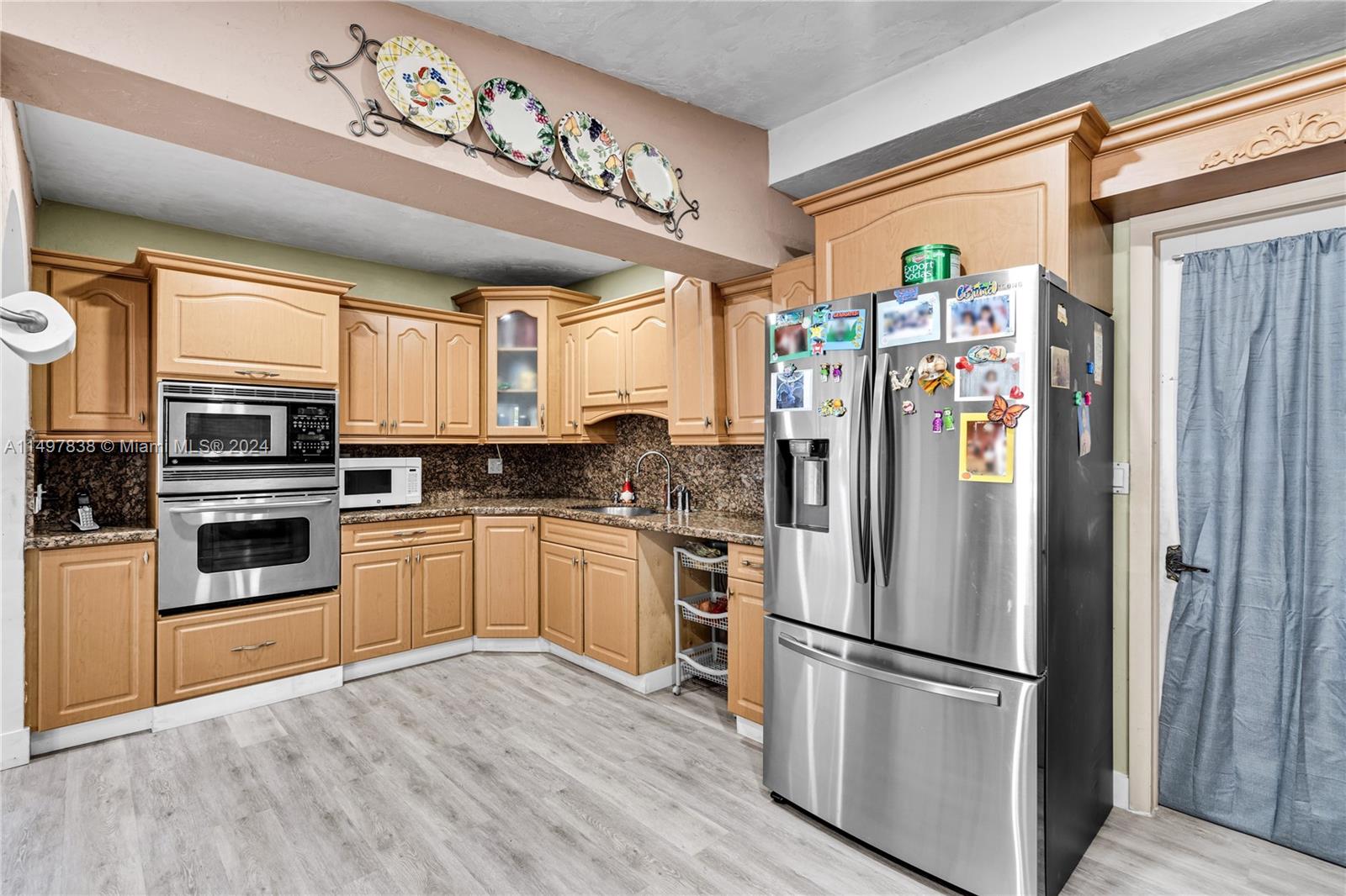 10981 Southwest 44th Street Miami, FL 33165 - Photo 18 of 52 a kitchen with stainless steel appliances a refrigerator sink and microwave