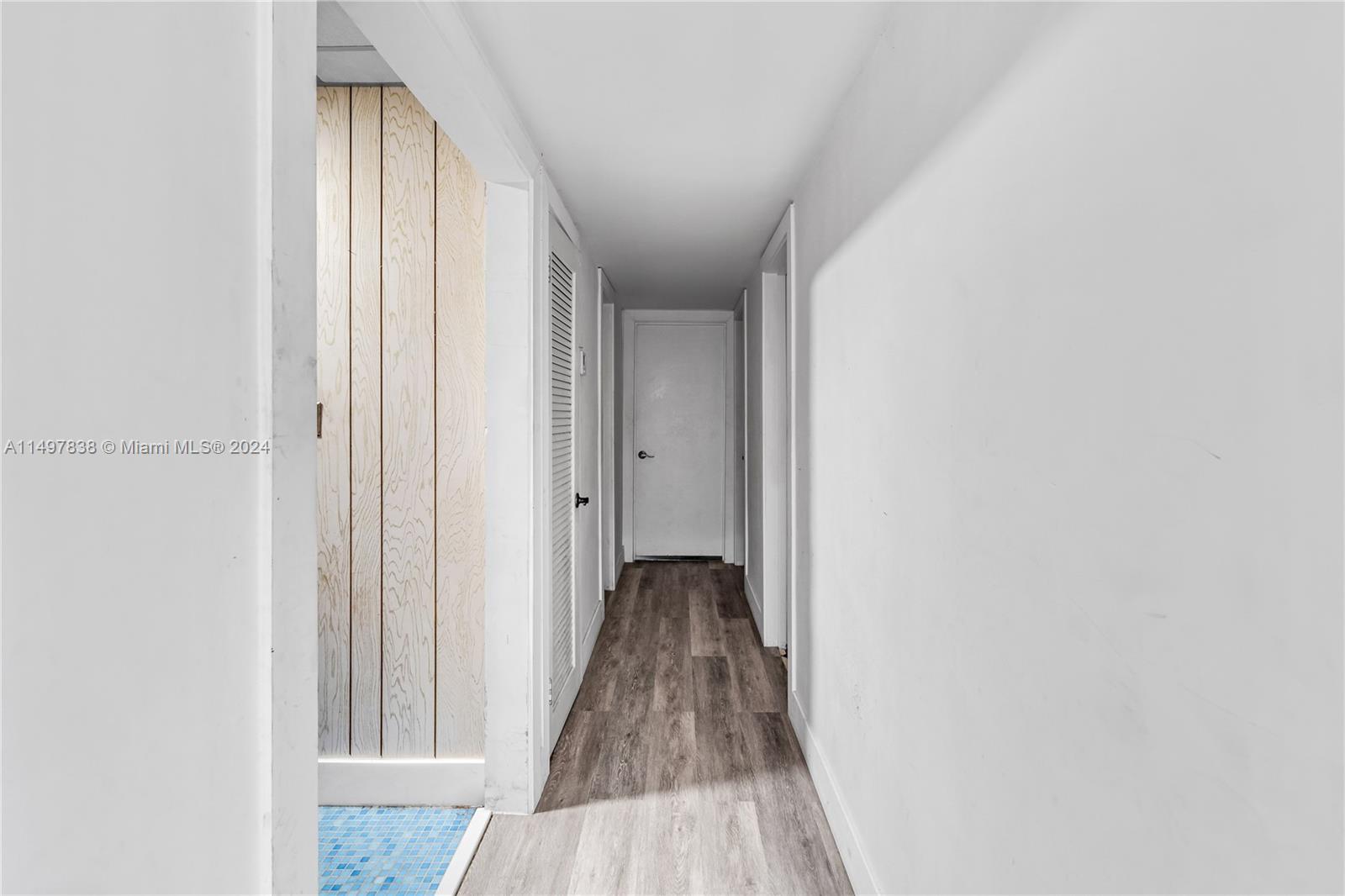 10981 Southwest 44th Street Miami, FL 33165 - Photo 22 of 52 a view of a hallway with a hardwood floor