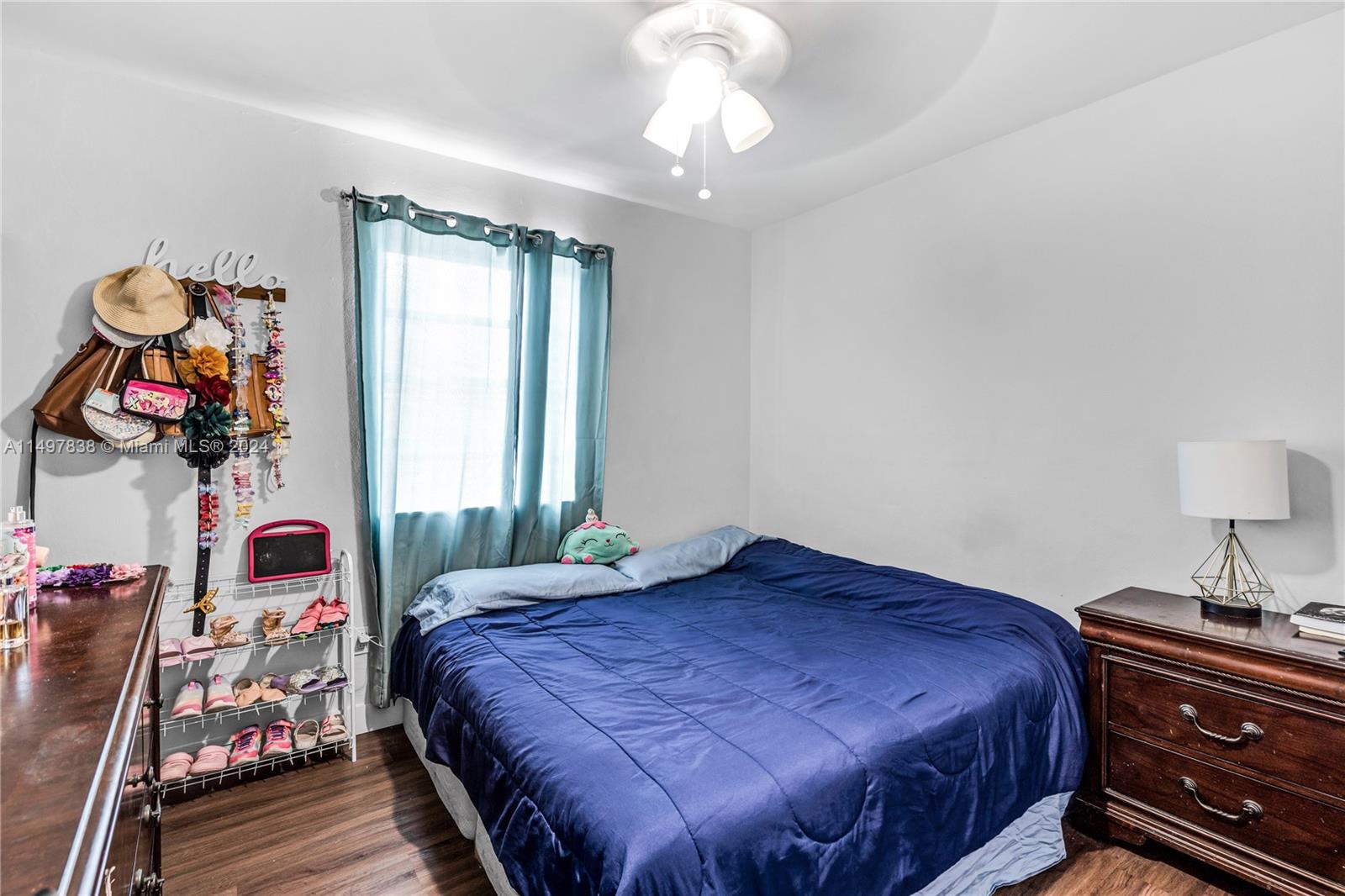 10981 Southwest 44th Street Miami, FL 33165 - Photo 23 of 52 a bedroom with a bed and dresser with wooden floor