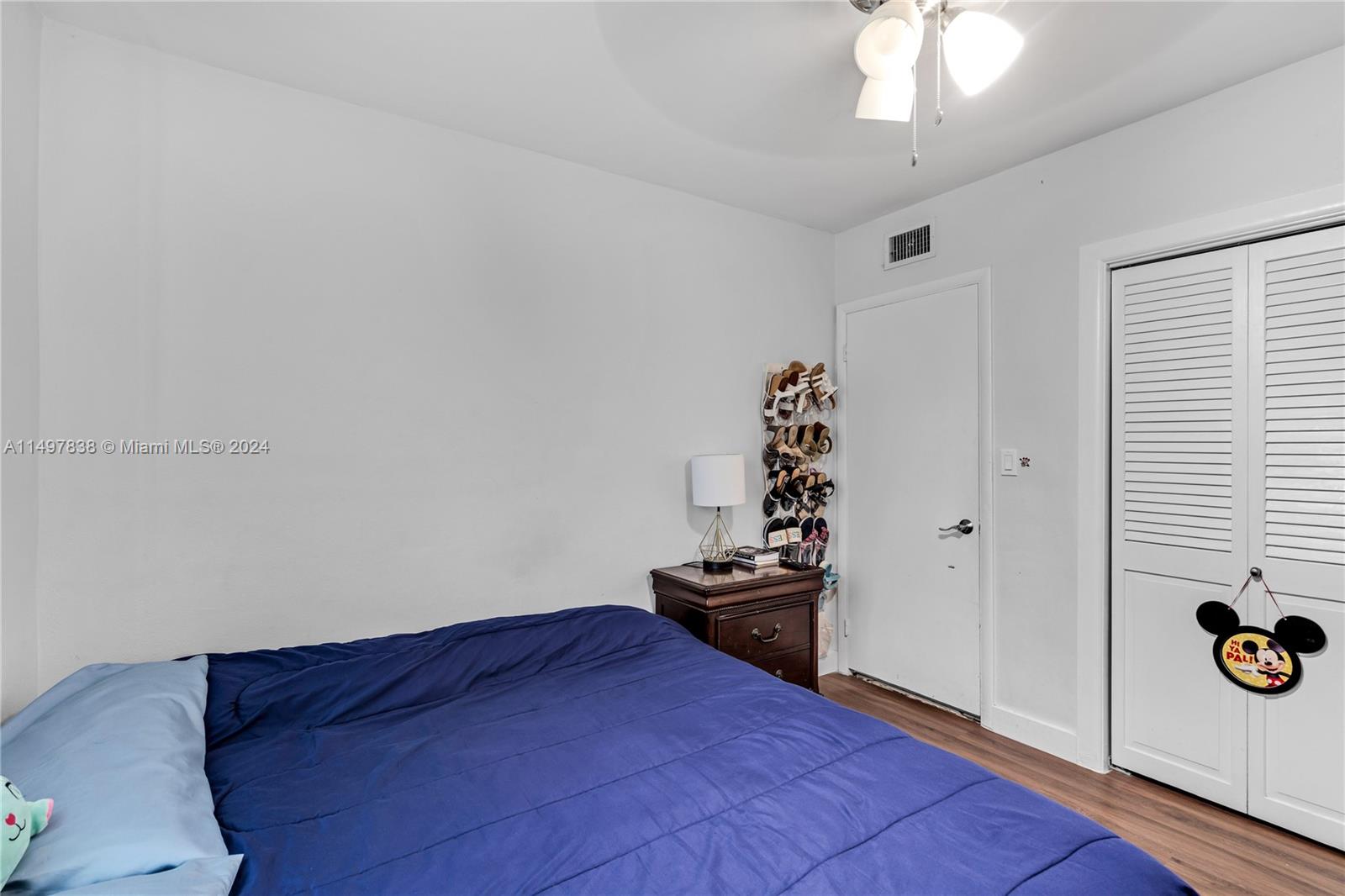 10981 Southwest 44th Street Miami, FL 33165 - Photo 24 of 52 a bedroom with a bed and a dresser