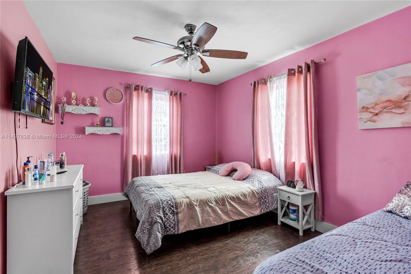 10981 Southwest 44th Street Miami, FL 33165 - Photo 25 of 52 a bedroom with a bed dresser and flat screen tv