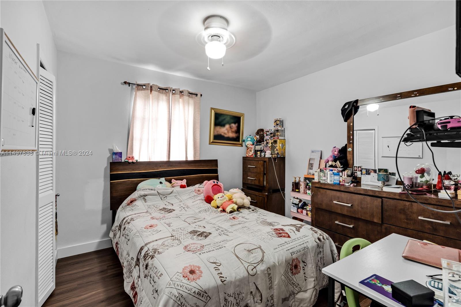 10981 Southwest 44th Street Miami, FL 33165 - Photo 27 of 52 a bedroom with a bed and a table