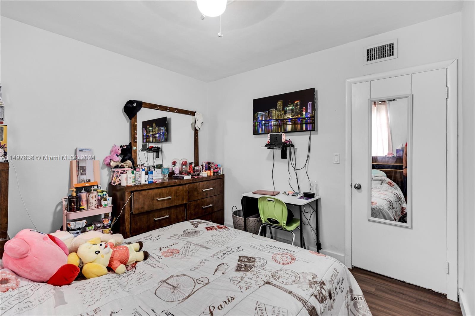 10981 Southwest 44th Street Miami, FL 33165 - Photo 28 of 52 a bed room with a bed a dresser and mirror