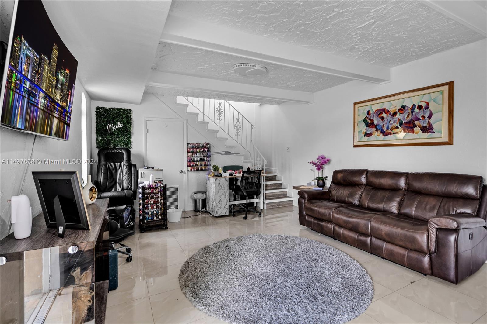 10981 Southwest 44th Street Miami, FL 33165 - Photo 31 of 52 a living room with furniture a fireplace and a flat screen tv
