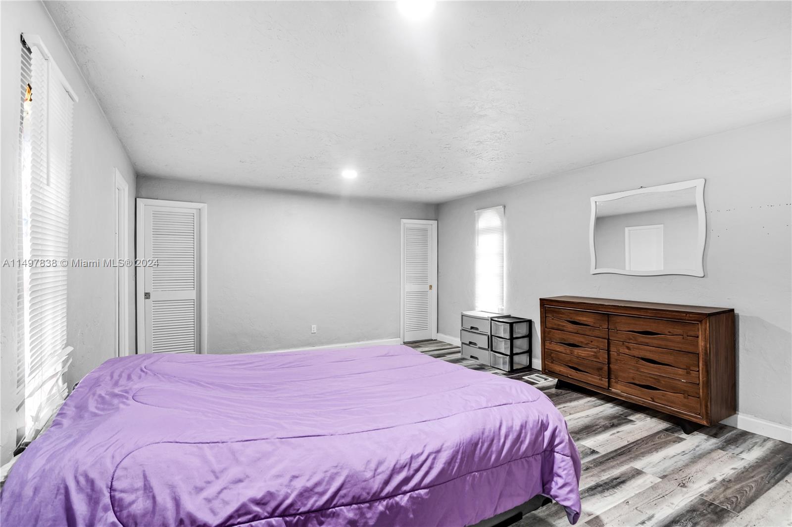 10981 Southwest 44th Street Miami, FL 33165 - Photo 35 of 52 a bedroom with a bed and a dresser